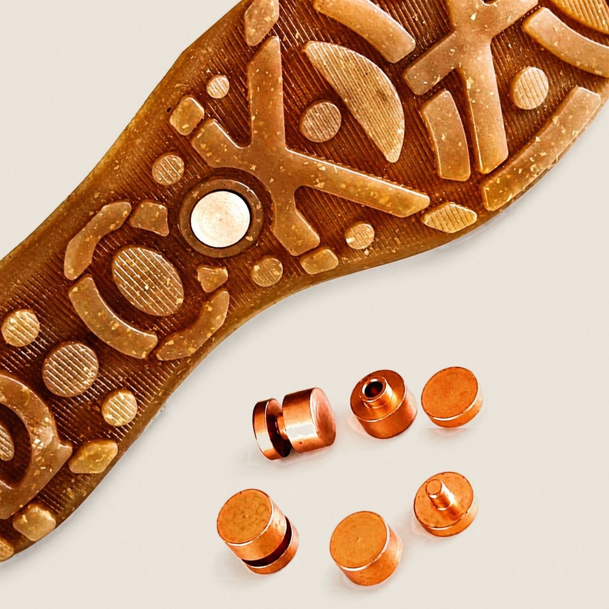 The underside of a ROKHZ sole with its copper elements beside it